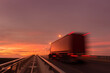 © Piyanat - Blurred motion truck on the road with Sunset