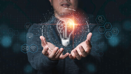 Fototapete - Businessman holding half of virtual lightbulb and brain on blue bokeh background , Smart thinking idea and inspiration innovation concept.