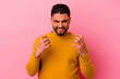 © Asier - Young mixed race man isolated on pink background