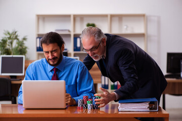 Canvas Print - Two male employees in gambling concept