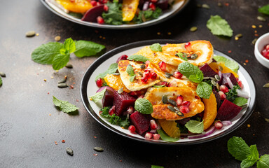 Wall Mural - Fried Halloumi Cheese salad with beetroot, orange, pomegranate and pumpkin seeds, red onion, green vegetables. healthy food