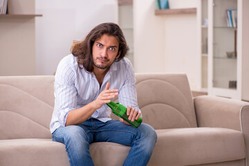 Poster - Young man drinking alcohol at home