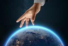 A Businessman's Hand Reaches For The Image Of The Earth From Space. Globalization Concept, Business To The Whole World, Online Business.