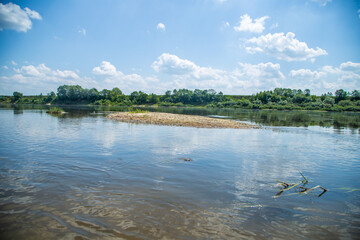 View of the Oka river from the shore, the opposite Bank is visible . The sky is reflected in the water