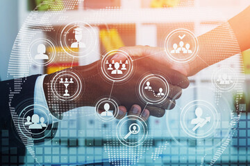 Poster - Two businesspeople shake hands after making a good deal. Office interior on background. Concept of negotiations and recruitment process