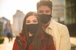 Romantic happy couple wearing masks against coronavirus covid 19 pandemic