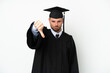 © luismolinero - Young university Brazilian graduate isolated on white background showing thumb down with negative expression
