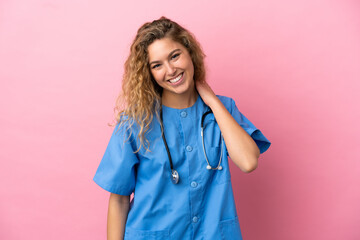 Wall Mural - Young surgeon doctor woman isolated on pink background laughing