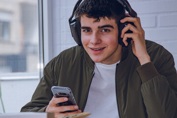 Sticker - teen at home with headphones and mobile phone