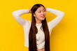 © Asier - Young chinese woman isolated on yellow background feeling confident, with hands behind the head.