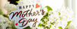 Lilac flowers and text Happy Mothers Day. Card with the lettering Mother's Day, greetings card. Beautiful bouquet with spring flowers.web banner