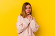 © Asier - Young caucasian skinny woman isolated on yellow background scared and afraid.