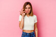 © Asier - Young caucasian woman isolated on pink background with fingers on lips keeping a secret.