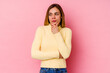 © Asier - Young caucasian woman isolated on pink background thinking and looking up, being reflective, contemplating, having a fantasy.