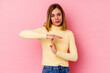 © Asier - Young caucasian woman isolated on pink background showing a timeout gesture.