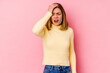 © Asier - Young caucasian woman isolated on pink background forgetting something, slapping forehead with palm and closing eyes.