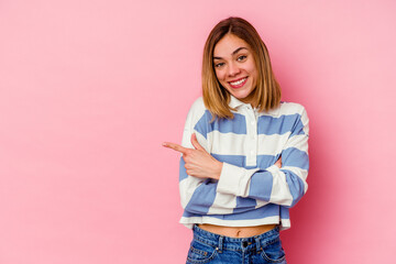 Sticker - Young caucasian woman isolated on pink background smiling cheerfully pointing with forefinger away.