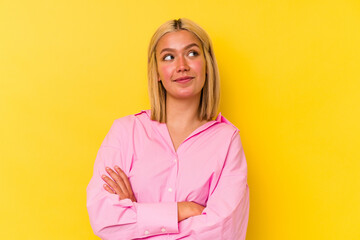 Poster - Young venezuelan woman isolated on yellow background dreaming of achieving goals and purposes