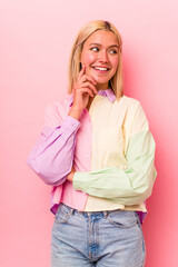 Wall Mural - Young caucasian woman face closeup isolated on pink background