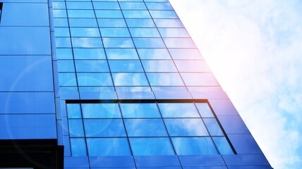 Downtown corporate business district architecture. Glass reflective office buildings against blue sky and sun light. Rising sun on the horizon. Velvia graphic filter.