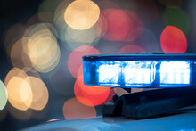 Blue Lights On The Roof Of A Police Car With The Background Out Of Focus And Lights With Bokeh Effect