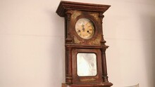 Broken Antique Mechanical Wall Clock That Once Showed The Hour In Room. Time