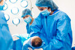 © Art_Photo - Professional anesthesiologist doctor medical team and assistant is performing baby cesarean section and hold the newborn baby giving birth with surgery equipment in modern hospital operation room