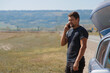 © aaalll3110 - a man makes a phone call. the tourist stopped on the road. travel by car. calling for car repairs