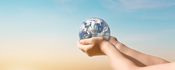 Canvas Print - environment day concept, globe in hands over blue sky background. save of earth. elements of this im