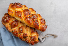 Homemade braided  Challah bread decorated with sesame seeds. Top view. Light grey background. Copy space.