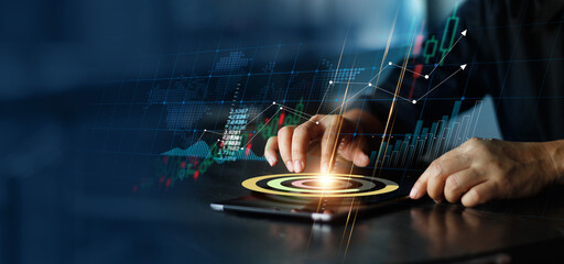 Poster - Businessman touching pie chart on tablet and analyzing sales data and economic growth graph chart. Financeial. Stock market and banking on dark background.