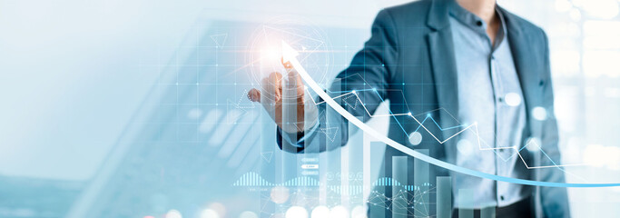 Businessman pointing arrow graph growth and financial network connection, analysing data to increase sales and revenue profit to achieve business investment goal in global economic situation.
