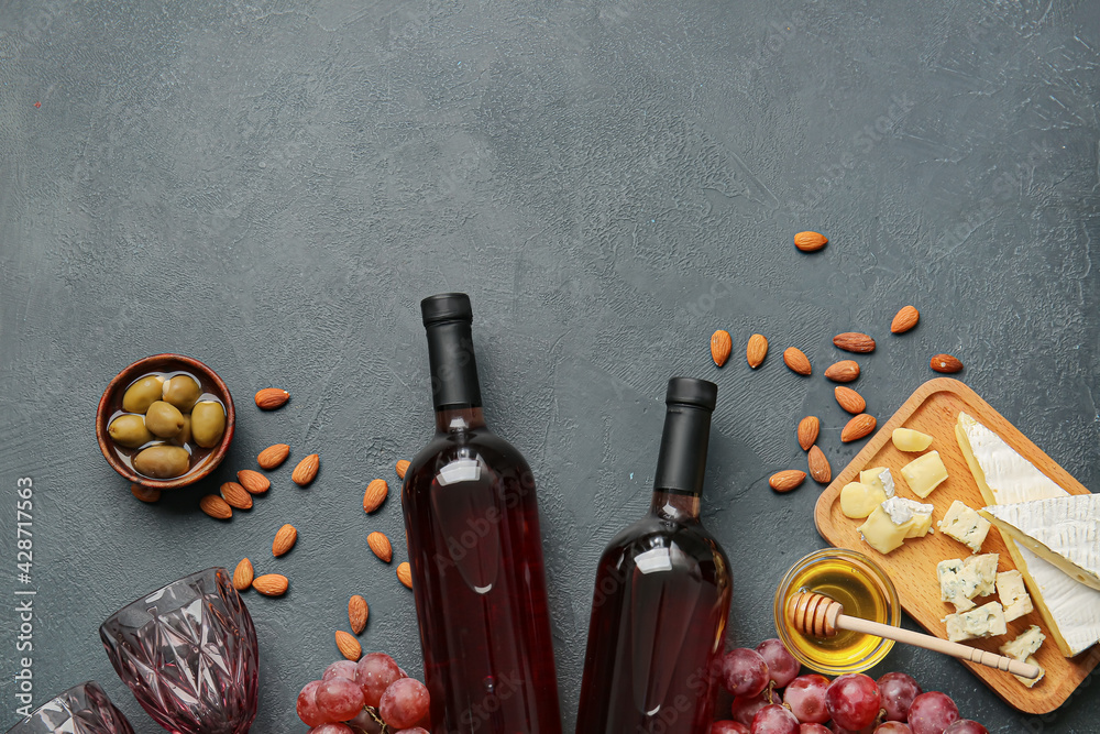 Composition with bottles of wine on dark background