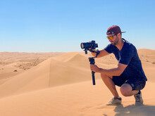Filmmaker Shooting In The Desert Sand Dunes