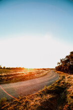 Portrait Vertical Image Of Sun Setting On Country Road In Central Victoria, Australia. Late Afternoon In Australia.