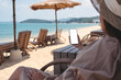 © Farknot Architect - Mockup image of a woman holding mobile phone with blank desktop screen while sitting on the beach