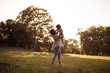 © liderina - Happy autumn day.  African American father and daughter having fun outdoors.