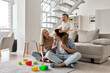 © insta_photos - Happy young family couple having fun playing with happy cute kid boy sitting on dads shoulders in modern living room. Parents and toddler child son enjoying spending time sitting on floor at home.