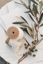 Meditterannean Summer Wedding Still Life. Blank Cotton Paper Invitations, Olive Tree Branch And Silk Chiffon Spools In Sunlight. Blank Invitation Cards. Selective Focus, Blurred Background, Top View