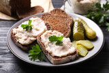 Fototapeta  - Delicious sandwiches with lard spread on black wooden table, closeup