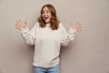 Wall Mural - Young excited woman screaming and gesturing at camera