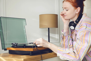 Poster - Beautiful young woman using turntable at home