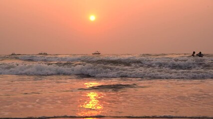 Wall Mural - Beautiful view sunset over the sea, ocean waves crashing on the beach shore