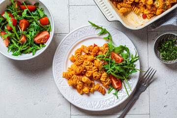 Wall Mural - Baked pasta with chicken and cheese in white plate,top view, gray background. Italian cuisine concept.