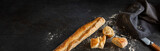 Fototapeta Desenie - Fresh crispy french baguette on black background. Atmosphäric food photography with space for text.
