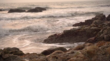 Wall Mural - Beautiful view sunset over the sea, ocean waves crashing on the beach shore