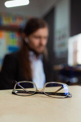 Transparent glasses on the table man blurred on the background