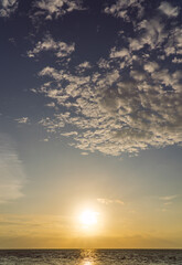 Wall Mural - sunset sky vertical over sea in the evening with colorful orange sunlight, dusk sky background.
