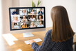 © Vadim Pastuh - Conference, morning meeting online. A young woman is using laptop for connection with diverse colleagues, multiracial employees. Video call with many people together. Back view