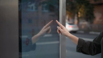 Smart retail sales and robot assistant or adviser technology concept. Woman using robo-advisor display text on screen in shop warehouse. Big navigation touchscreen, big touch screen outdoor on street